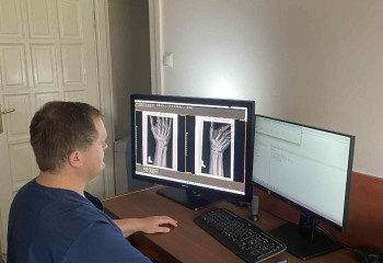 Słuchacz kierunku technik elektroradiolog wykonuje obróbkę zdjęcia rentgenowskiego przy komputerze.